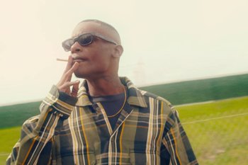 Movie still from “Huey Briss & Nikobeats - Grace Park Legend” (2021), directed by Michael Priestley – Medium shot, Low angle