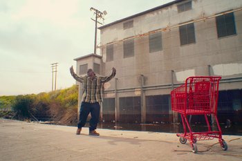 Movie still from “Huey Briss & Nikobeats - Grace Park Legend” (2021), directed by Michael Priestley – Wide shot, Low angle