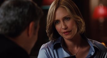 Movie still from “Up in the Air” (2009), directed by Jason Reitman – A person sitting at a table; Close Up shot, Over the shoulder angle