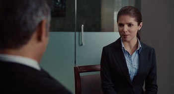 Movie still from “Up in the Air” (2009), directed by Jason Reitman – A man and a woman sitting in front of each other in a room; Medium shot, Over the shoulder angle