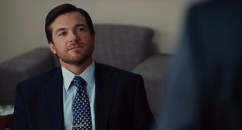 Movie still from “Up in the Air” (2009), directed by Jason Reitman – A person wearing a suit and tie; Close Up shot, Over the shoulder angle