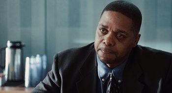 Movie still from “Up in the Air” (2009), directed by Jason Reitman – A person wearing a suit and tie; Close Up shot, Over the shoulder angle