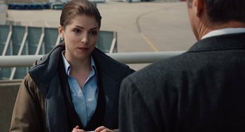 Movie still from “Up in the Air” (2009), directed by Jason Reitman – A woman sitting next to a man in a suit; Close Up shot, Over the shoulder angle