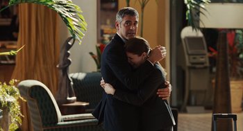 Movie still from “Up in the Air” (2009), directed by Jason Reitman – A man and a woman hugging in a living room; Medium shot, Over the shoulder angle