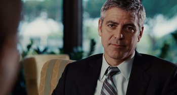 Movie still from “Up in the Air” (2009), directed by Jason Reitman – A person wearing a suit and tie; Close Up shot, Over the shoulder angle