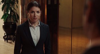 Movie still from “Up in the Air” (2009), directed by Jason Reitman – A woman in a suit standing in front of an elevator; Medium shot, Over the shoulder angle