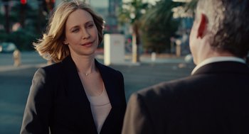 Movie still from “Up in the Air” (2009), directed by Jason Reitman – A woman in a black jacket is talking to a man in a black suit; Close Up shot, Over the shoulder angle