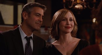 Movie still from “Up in the Air” (2009), directed by Jason Reitman – A man and a woman standing next to each other; Close Up shot, Over the shoulder angle