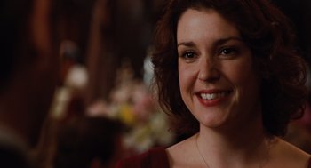 Movie still from “Up in the Air” (2009), directed by Jason Reitman – A person smiling for the camera; Close Up shot, Over the shoulder angle