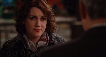 Movie still from “Up in the Air” (2009), directed by Jason Reitman – A person sitting in front of a table; Close Up shot, Over the shoulder angle