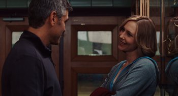 Movie still from “Up in the Air” (2009), directed by Jason Reitman – A man and a woman talking to each other; Medium shot, Over the shoulder angle