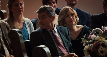 Movie still from “Up in the Air” (2009), directed by Jason Reitman – A group of people sitting in front of each other; Close Up shot, Over the shoulder angle