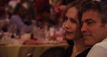 Movie still from “Up in the Air” (2009), directed by Jason Reitman – A person sitting at a table; Close Up shot, Over the shoulder angle