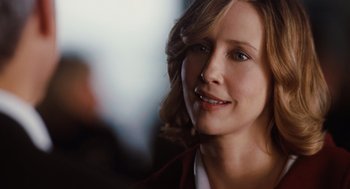 Movie still from “Up in the Air” (2009), directed by Jason Reitman – A person smiling for the camera; Close Up shot, Over the shoulder angle
