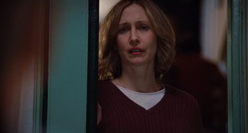 Movie still from “Up in the Air” (2009), directed by Jason Reitman – A woman standing in front of a mirror looking sad; Close Up shot, Over the shoulder angle