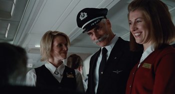 Movie still from “Up in the Air” (2009), directed by Jason Reitman – A man and woman standing next to each other; Medium shot, Low angle