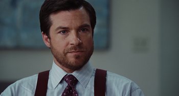 Movie still from “Up in the Air” (2009), directed by Jason Reitman – A person wearing a suit and a tie; Close Up shot, Over the shoulder angle