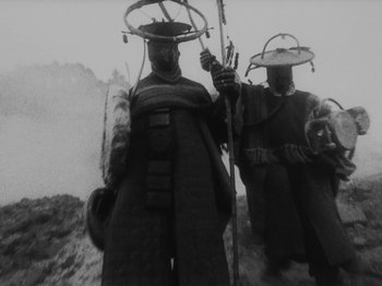 Movie still from “Ankobo + Kaboo - Wakangenei” (2020), directed by Felix Umarov – Medium shot, Low angle