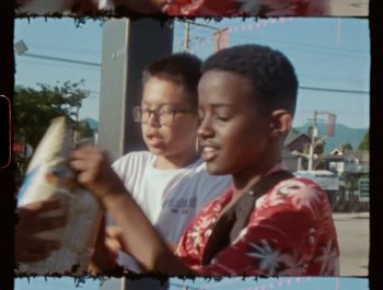 Movie still from “Flower Bomb - Come Together” (2020), directed by Benton Robertson – Medium shot, High angle
