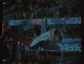 Movie still from “Flower Bomb - Come Together” (2020), directed by Benton Robertson – Medium shot, Low angle