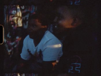 Movie still from “Flower Bomb - Come Together” (2020), directed by Benton Robertson – Medium shot, High angle