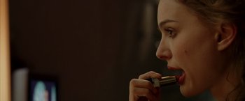 Movie still from “V for Vendetta” (2005), directed by James McTeigue – A person holding a pen in her mouth; Extreme Close Up shot, Over the shoulder angle