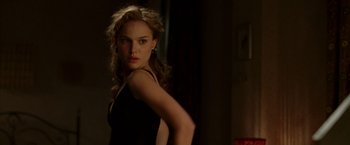 Movie still from “V for Vendetta” (2005), directed by James McTeigue – A beautiful young woman in a black dress; Medium shot, Over the shoulder angle