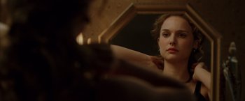Movie still from “V for Vendetta” (2005), directed by James McTeigue – A woman looking at herself in the mirror; Close Up shot, Over the shoulder angle