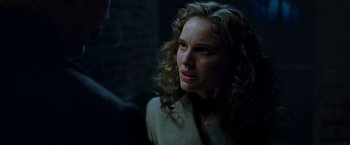 Movie still from “V for Vendetta” (2005), directed by James McTeigue – A person with curly hair; Close Up shot, Over the shoulder angle