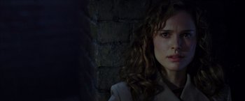 Movie still from “V for Vendetta” (2005), directed by James McTeigue – A person with curly hair; Close Up shot, Over the shoulder angle