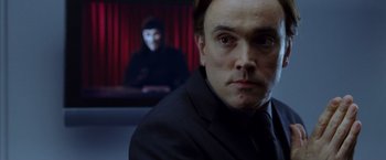 Movie still from “V for Vendetta” (2005), directed by James McTeigue – A person wearing a suit; Close Up shot, Over the shoulder angle