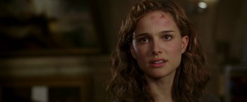 Movie still from “V for Vendetta” (2005), directed by James McTeigue – A woman with a scar on her forehead; Close Up shot, Over the shoulder angle