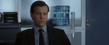 Movie still from “V for Vendetta” (2005), directed by James McTeigue – A person wearing a suit and tie; Close Up shot, Over the shoulder angle