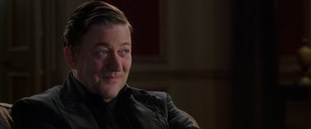 Movie still from “V for Vendetta” (2005), directed by James McTeigue – A person sitting in a chair; Close Up shot, Over the shoulder angle