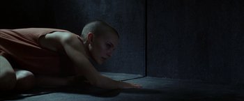 Movie still from “V for Vendetta” (2005), directed by James McTeigue – A young man laying on the ground in a dark room; Medium shot, High angle