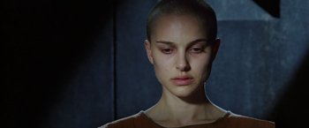 Movie still from “V for Vendetta” (2005), directed by James McTeigue – A person with a shaved head; Close Up shot, Low angle