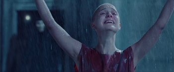 Movie still from “V for Vendetta” (2005), directed by James McTeigue – A young boy in a red shirt is in the rain; Close Up shot, Low angle