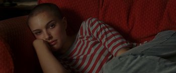 Movie still from “V for Vendetta” (2005), directed by James McTeigue – A woman laying on a couch with her head resting on her arm; Close Up shot, High angle