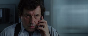 Movie still from “V for Vendetta” (2005), directed by James McTeigue – A person talking on a cell phone; Close Up shot, Low angle