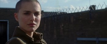 Movie still from “V for Vendetta” (2005), directed by James McTeigue – A person with a shaved head; Close Up shot, Over the shoulder angle