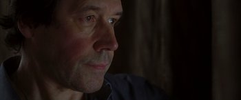 Movie still from “V for Vendetta” (2005), directed by James McTeigue – A man's face in the dark; Close Up shot, Low angle