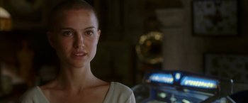 Movie still from “V for Vendetta” (2005), directed by James McTeigue – A person with a shaved head; Close Up shot, Over the shoulder angle