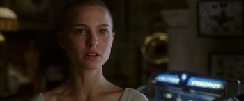 Movie still from “V for Vendetta” (2005), directed by James McTeigue – A person with a shaved head; Close Up shot, Over the shoulder angle