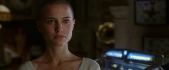 Movie still from “V for Vendetta” (2005), directed by James McTeigue – A person with a shaved head; Close Up shot, Over the shoulder angle