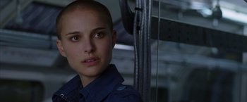 Movie still from “V for Vendetta” (2005), directed by James McTeigue – A person with a shaved head; Close Up shot, Over the shoulder angle