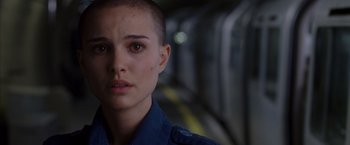 Movie still from “V for Vendetta” (2005), directed by James McTeigue – A person with a shaved head; Close Up shot, Over the shoulder angle