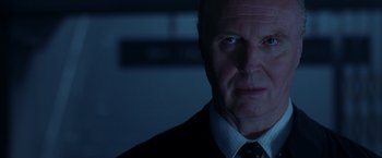 Movie still from “V for Vendetta” (2005), directed by James McTeigue – A person wearing a suit and tie; Close Up shot, Low angle