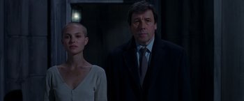 Movie still from “V for Vendetta” (2005), directed by James McTeigue – A man and a woman standing next to each other; Medium shot, Low angle