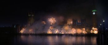 Movie still from “V for Vendetta” (2005), directed by James McTeigue – Fireworks exploding over a city at night with a body of water in the foreground; Extreme Wide shot, Low angle
