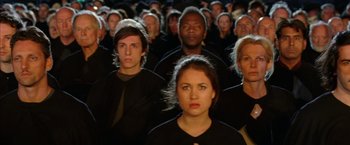Movie still from “V for Vendetta” (2005), directed by James McTeigue – A large group of people in all black clothes; Medium shot, High angle
